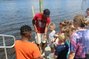 group of children looking a crab